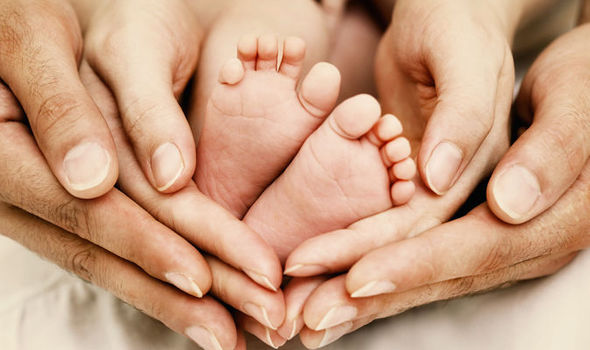 Baby feet and parents' hands